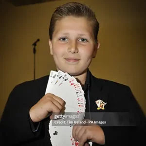 Lewis as child magician with a pack of cards